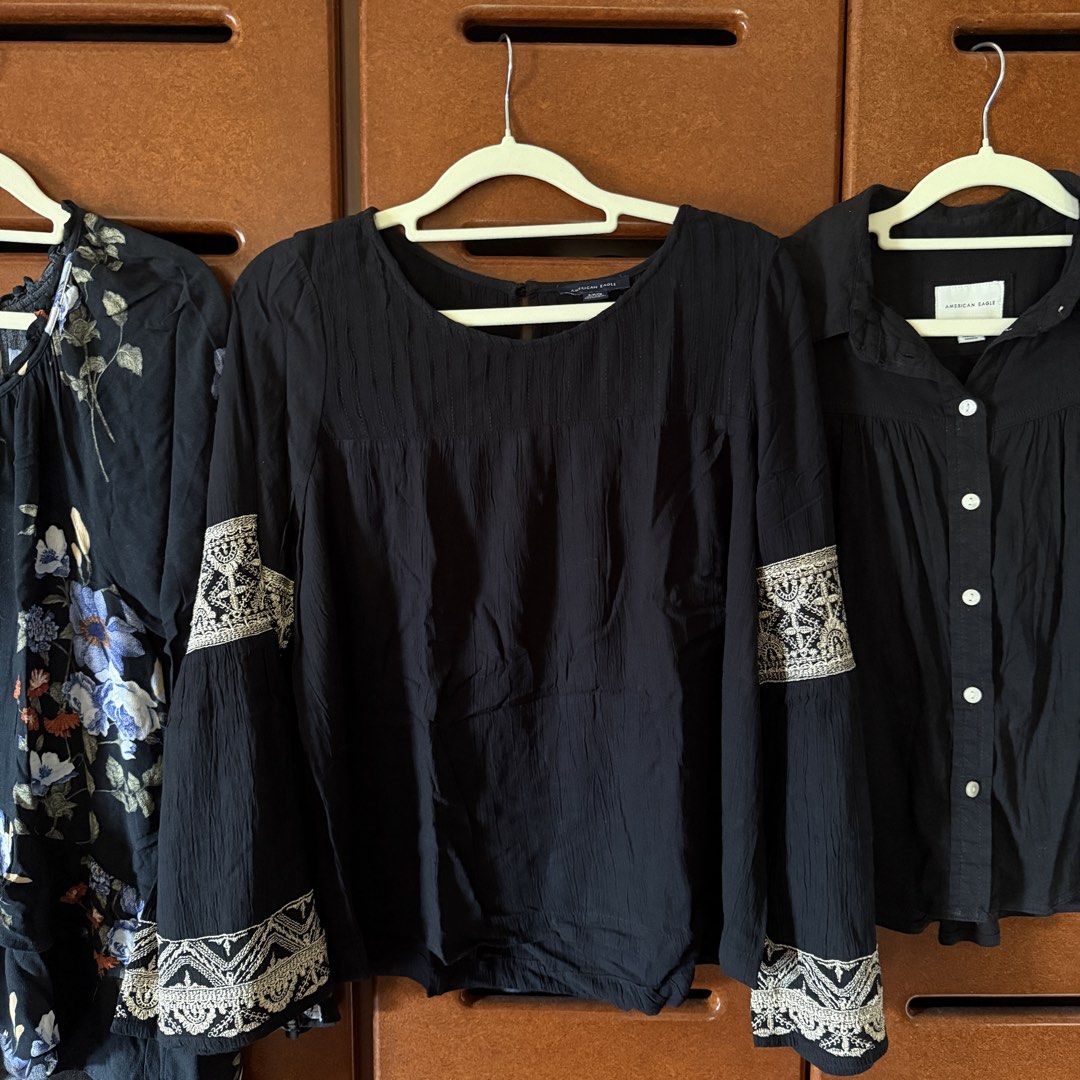American Eagle Black Blouse Size S (Category: Longsleeves) located in Davao. Submitted by keirousel (Listing ID 1466034122, Image 1). Description: - Brand: American Eagle - Size: S - Color: Black with white and beige embroidery - Style: Round neck, pleated front panel, wide bell sleeves - Material: Lightweight and comfortable - Condition: Excellent pre-loved condition - Perfect for both casual days and evening wear.