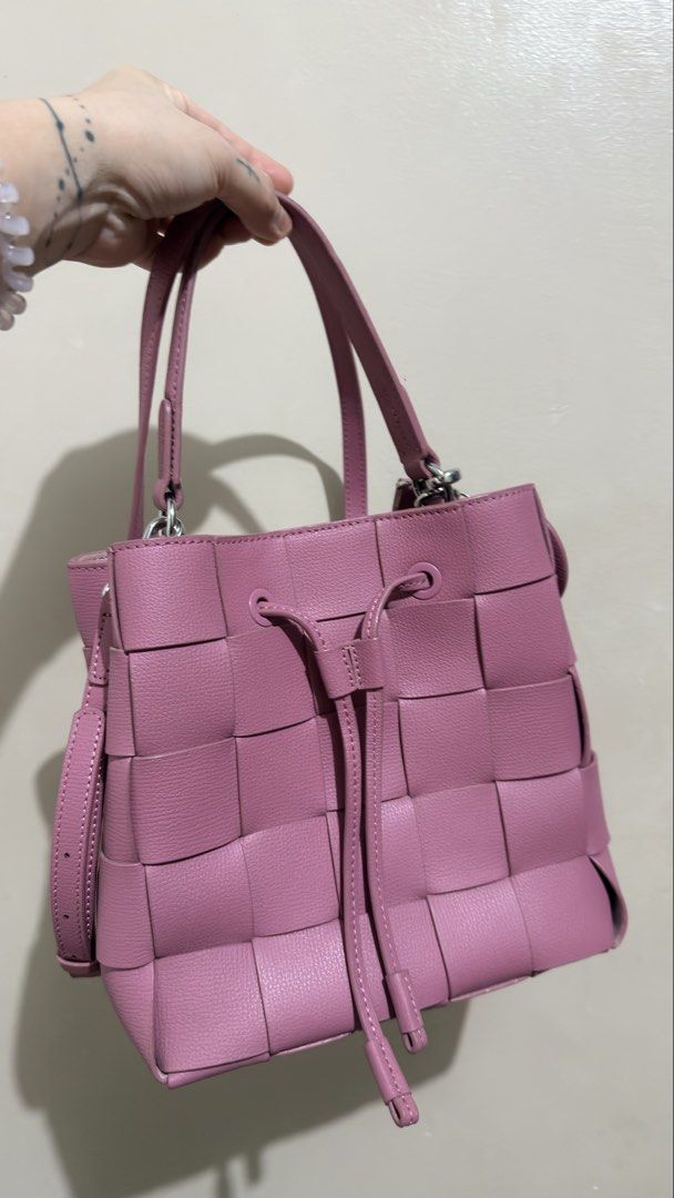 Anne Klein Bucket Bag (Category: Shoulder Bags) located in Las Pinas. Submitted by mharjrahm (Listing ID 1465954106, Image 1). Description: - Style: Woven leather bucket bag with intrecciato-style pattern - Color: Vibrant pink - Closure: Front drawstring with dangling knot ends - Straps: Dual top handles plus a detachable longer side strap - Hardware: Silver-toned - Size & Structure: Medium size with a clean, structured silhouette - Use: Perfect 