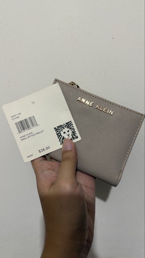 Anne Klein Small Bi-Fold Wallet in Stone (Category: Wallets & Card holders) located in Rizal. Submitted by lovegclothingph (Listing ID 1466094486, Image 1). Description: - Brand: Anne Klein (Model AKW1198) - Condition: Looks new with original store tag - Color: Elegant stone - Material: Textured finish with gold-tone hardware - Features: Bi-fold design with a convenient top zipper coin compartment - Retail Price: $38.00 - RFS: Decluttering.