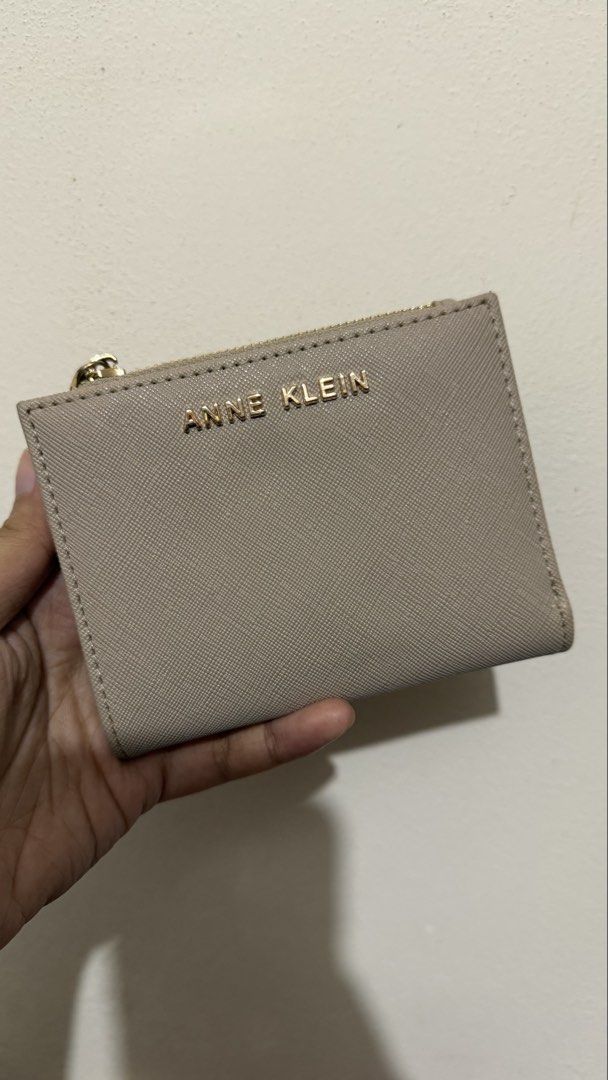 Anne Klein Small Bi-Fold Wallet in Stone (Category: Wallets & Card holders) located in Rizal. Submitted by lovegclothingph (Listing ID 1466094486, Image 2). Description: - Brand: Anne Klein (Model AKW1198) - Condition: Looks new with original store tag - Color: Elegant stone - Material: Textured finish with gold-tone hardware - Features: Bi-fold design with a convenient top zipper coin compartment - Retail Price: $38.00 - RFS: Decluttering.