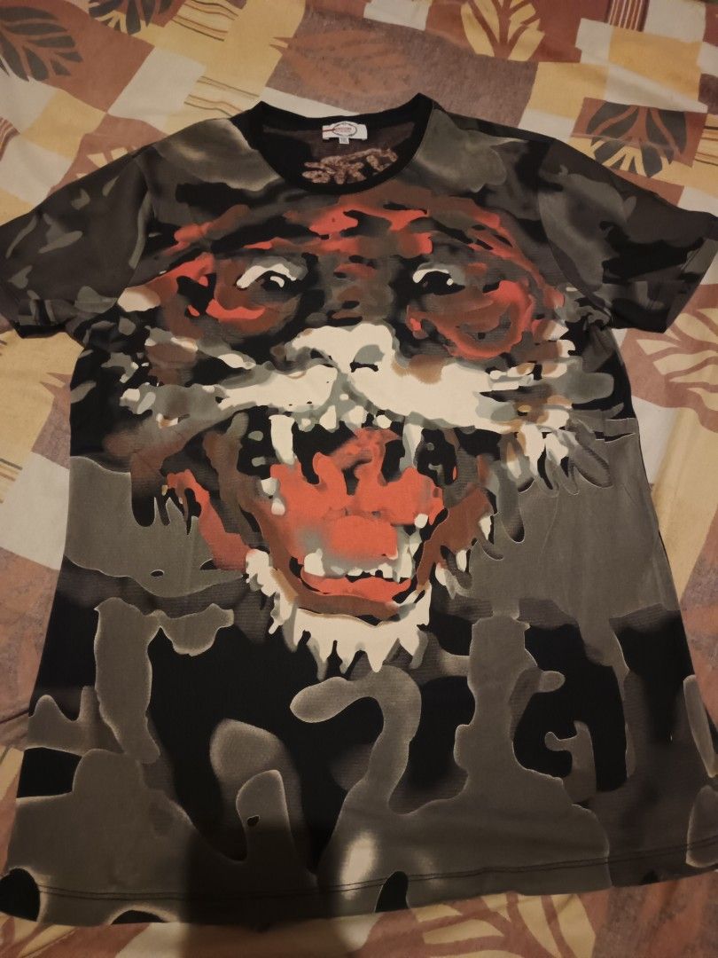 AOP tshirt (Category: Activewear) located in Odiongan. Submitted by thriftngo26 (Listing ID 1466085953, Image 1). Description: This appears to be a short-sleeve crewneck t-shirt featuring a large, stylized roaring tiger graphic across the chest against a dark camo or patterned background.
