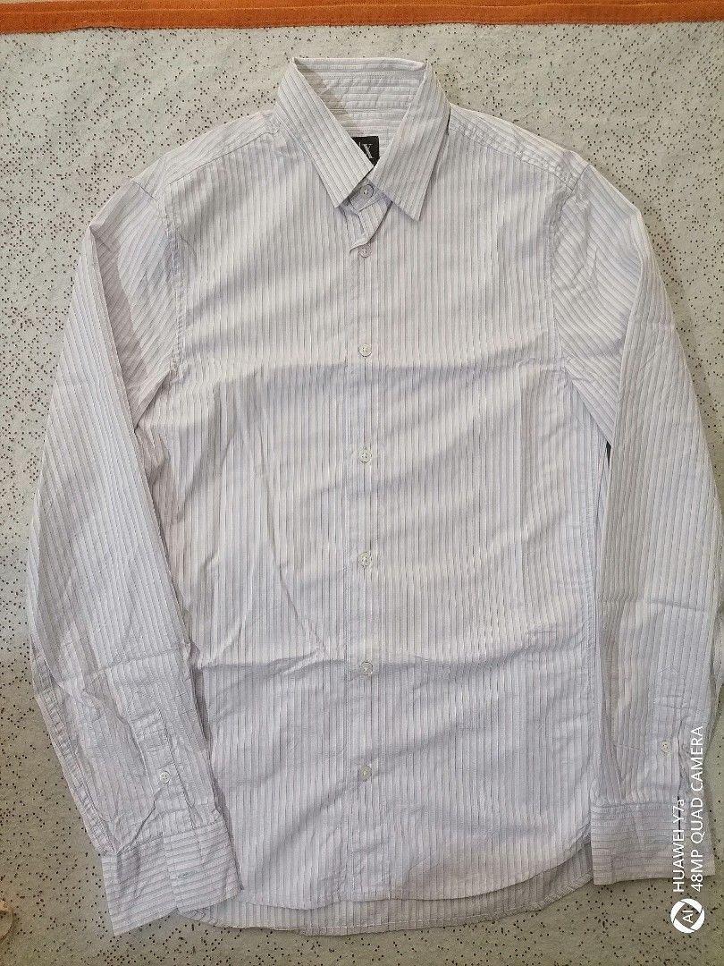 Armani Exchange Slim Fit Striped Button-Down Shirt Size S (Category: Tshirts & Polo Shirts ) located in Naga. Submitted by mrwisethrifter (Listing ID 1465984574, Image 1). Description: - Brand: Armani Exchange - Style: Slim fit long sleeve button-down shirt - Pattern: Blue and white vertical stripes - Size: S/P - Details: Classic collar, branded front and cuff buttons - Condition: Clean fabric throughout, well-maintained.