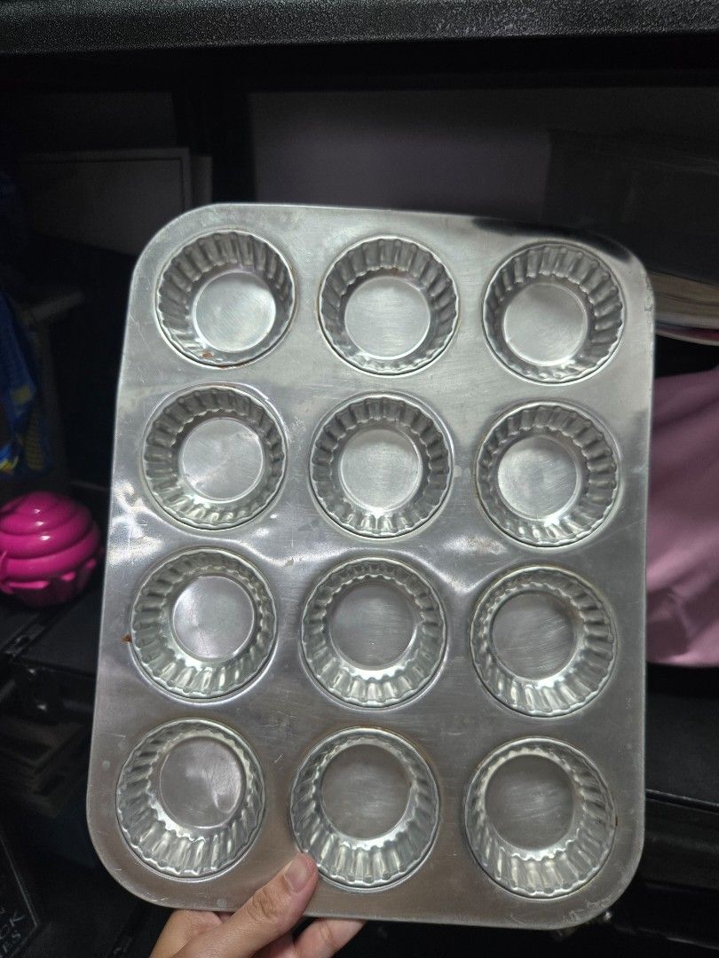 Assorted Kitchenware (Category: Bakeware) located in Singapore. Submitted by payit4ward (Listing ID 1465958052, Image 1). Description: - 12-cup metal baking tray with fluted design - Standard size ideal for cupcakes, muffins, and mini tarts - Durable heavy-duty construction - Silver finish - Clean surface with minor storage marks.