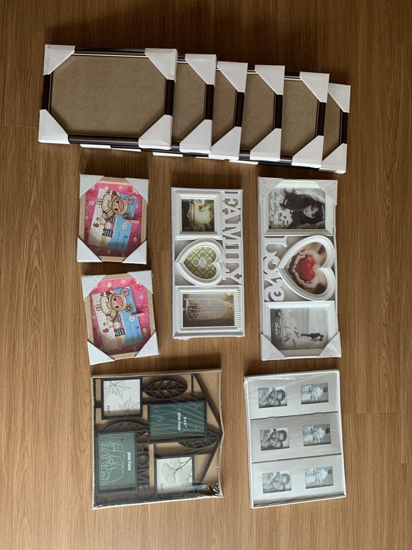 Assorted Photo Frames Bundle Picture Frames Set (Category: Frames & Pictures) located in Singapore. Submitted by highfiv (Listing ID 1465967986, Image 1). Description: Variety of photo frames in different sizes and styles. Includes multi-photo collage frames with 'FAMILY' and 'LOVE' lettering, wooden frames, and tabletop displays. Most frames still have corner protectors and original packaging intact. Great for displaying memories around the hous