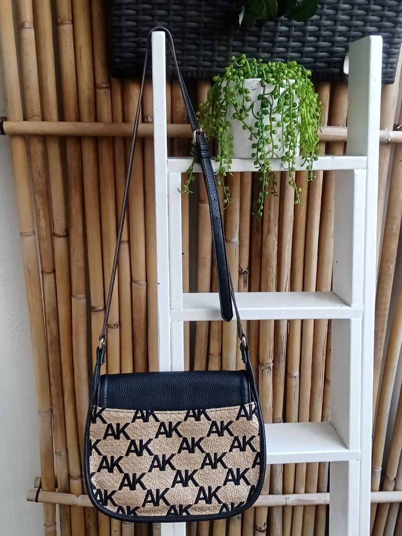 Authentic Anne Klein Crossbody Bag (Category: Cross-body Bags) located in Quezon City. Submitted by beccathrift (Listing ID 1466112571, Image 2). Description: Authentic Anne Klein Anne Klein crossbody bag in black pebbled faux leather and tan straw material with an all-over AK monogram print. Includes a gold chain accent and magnetic closure. Adjustable long strap attached. Interior is lined with monogram fabric, featuring zip and slip pockets. B