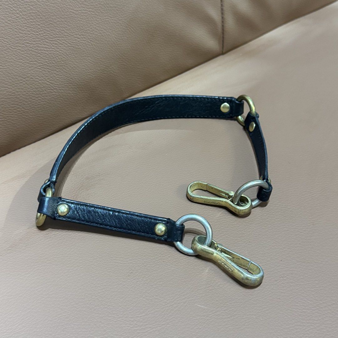 Authentic Coach Black Leather Replacement Bag Strap with Gold and Silver Hardware (Category: Luxury Bags & Wallets) located in Rizal. Submitted by houseofbell (Listing ID 1466151527, Image 3). Description: Authentic Coach leather handbag strap in black. Measures around 25 inches long end to end. Features gold and silver tone hardware with Coach logo engraving on the clasp clips. Solid brass and metal rings linking the leather sections together. G
