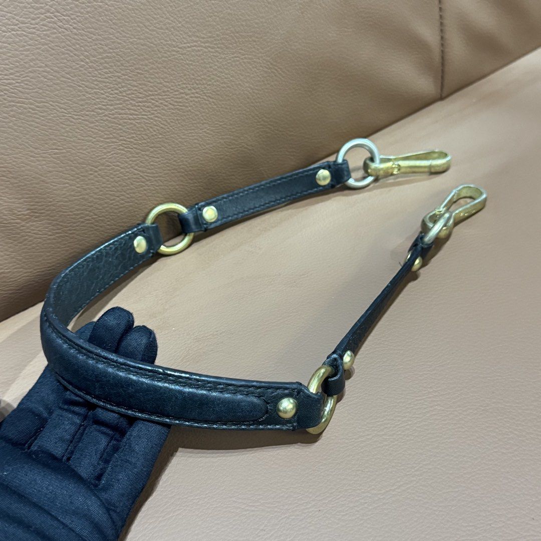Authentic Coach Black Leather Replacement Bag Strap with Gold and Silver Hardware (Category: Luxury Bags & Wallets) located in Rizal. Submitted by houseofbell (Listing ID 1466151527, Image 1). Description: Authentic Coach leather handbag strap in black. Measures around 25 inches long end to end. Features gold and silver tone hardware with Coach logo engraving on the clasp clips. Solid brass and metal rings linking the leather sections together. G
