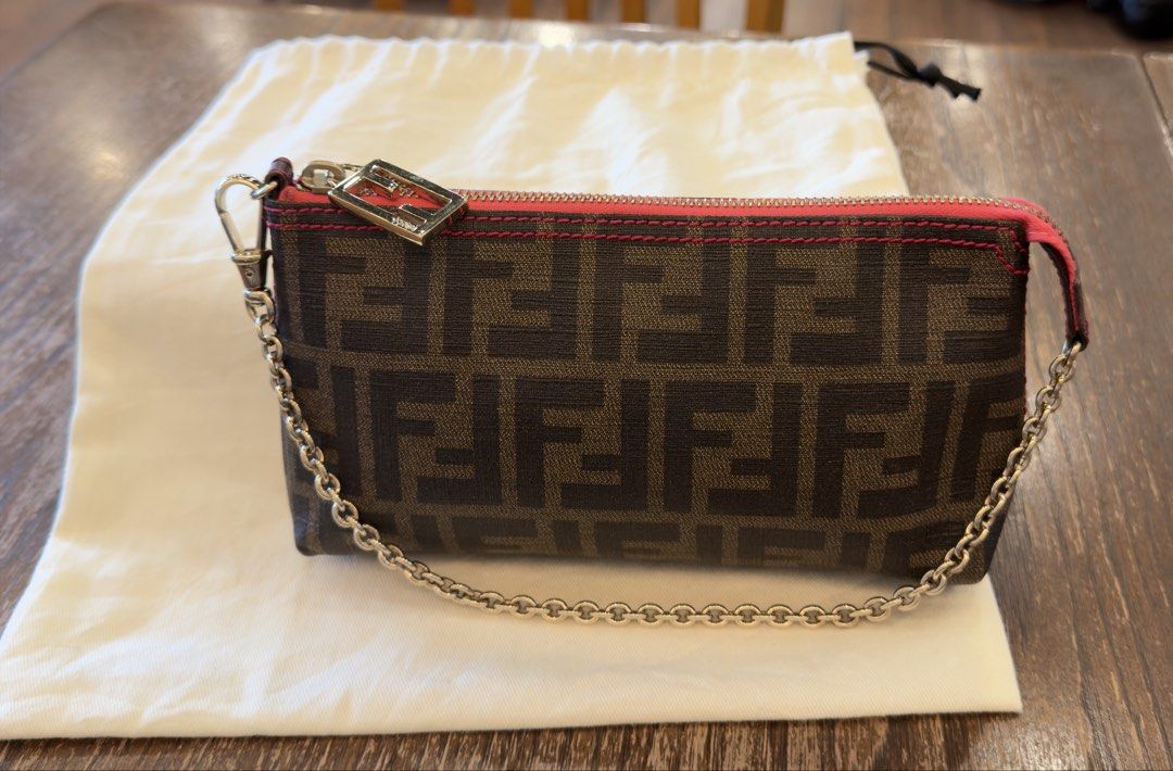 Authentic Fendi Zucca Pochette (Category: Luxury Bags & Wallets) located in Angat. Submitted by shopmyclosetbykris (Listing ID 1466075924, Image 2). Description: Very hard to find Authentic Fendi Zucca Pochette With pink detail, shiny gold hardware Condition: Good as new Comes with dustbag Retails at 76k plus Selling for only 39k LP Posted! Location: Baliwag Bulacan Can do meet ups within Bulacan or QC.