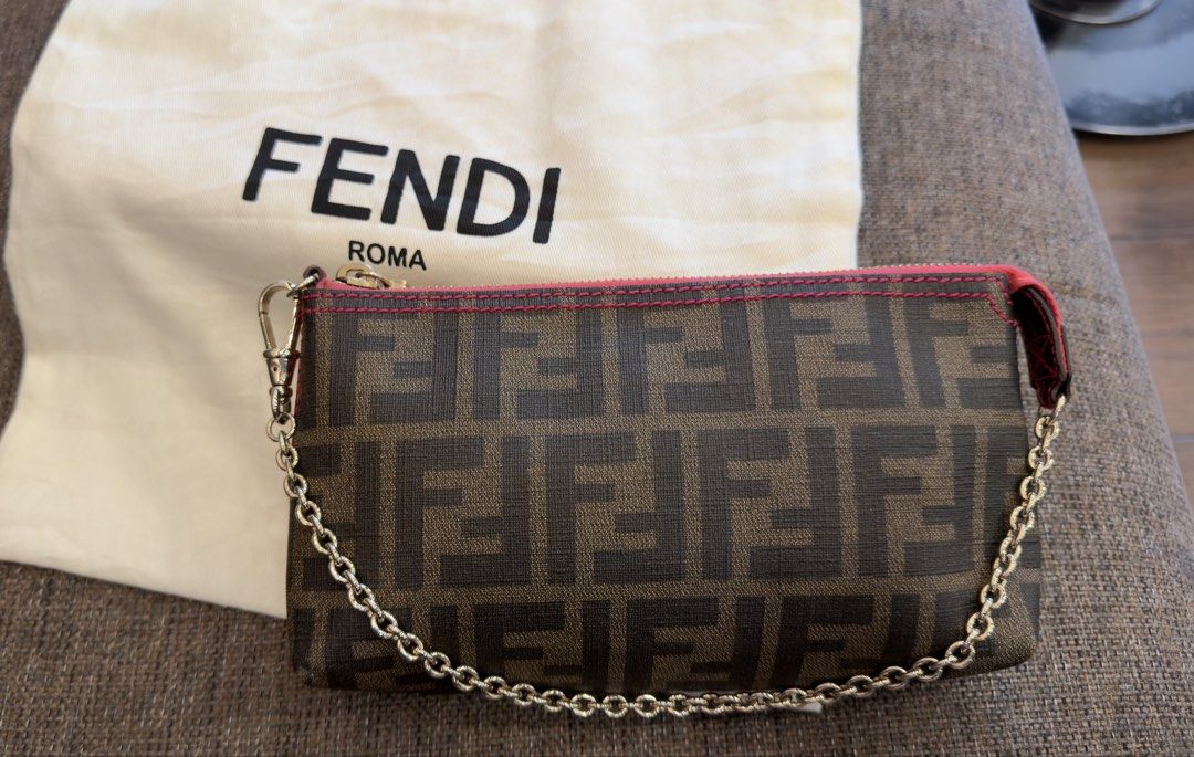 Authentic Fendi Zucca Pochette (Category: Luxury Bags & Wallets) located in Angat. Submitted by shopmyclosetbykris (Listing ID 1466075924, Image 1). Description: Very hard to find Authentic Fendi Zucca Pochette With pink detail, shiny gold hardware Condition: Good as new Comes with dustbag Retails at 76k plus Selling for only 39k LP Posted! Location: Baliwag Bulacan Can do meet ups within Bulacan or QC.