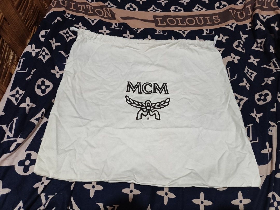 Authentic MCM Dust Bag White Drawstring (Category: Luxury Bags & Wallets) located in Maasim. Submitted by ukayganda25 (Listing ID 1466034381, Image 1). Description: - Brand: MCM - Color: White with black logo - Material: Soft fabric - Closure: Drawstring with white cords - Condition: Clean, folded for storage - Ideal for: Storing and protecting handbags or accessories.
