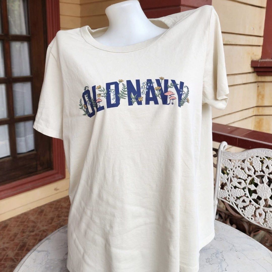 Authentic Old Navy Botanical Graphic T-Shirt (Category: Shirts) located in Batangas. Submitted by lux_kimmy (Listing ID 1466056328, Image 3). Description: - Brand: Old Navy - Color: Cream with blue collegiate floral/mushroom graphic - Material: Soft cotton - Fit: Classic crew neck, short sleeves - Sizes Available: XS, S, M, L, XL, 2XL - Condition: Brand new with store tags in original plastic packaging Bought in US Authentic Old navy 380 each FIX