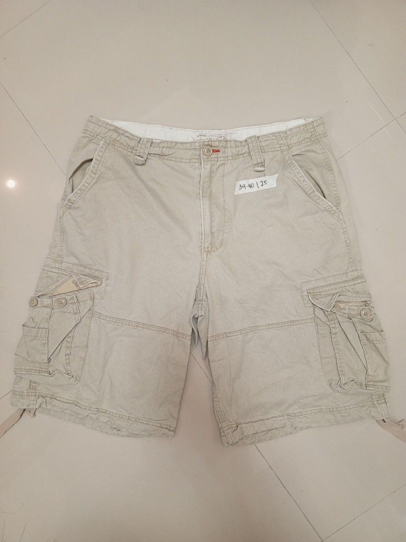 Authentic Trailwear Beige Cargo Shorts Size 38 (Category: Shorts) located in Orani. Submitted by thriftniea (Listing ID 1466041559, Image 1). Description: SIZE 40 LENGTH 25 - Brand: Authentic Trailwear - Size: 38 - Color: Classic beige - Style: Heavy utility cargo shorts - Features: Multiple side and back pockets, button closures, and drawstrings at the leg hems - Durability: Sturdy fabric with double-stitched seams - Condition: Great for outdoor