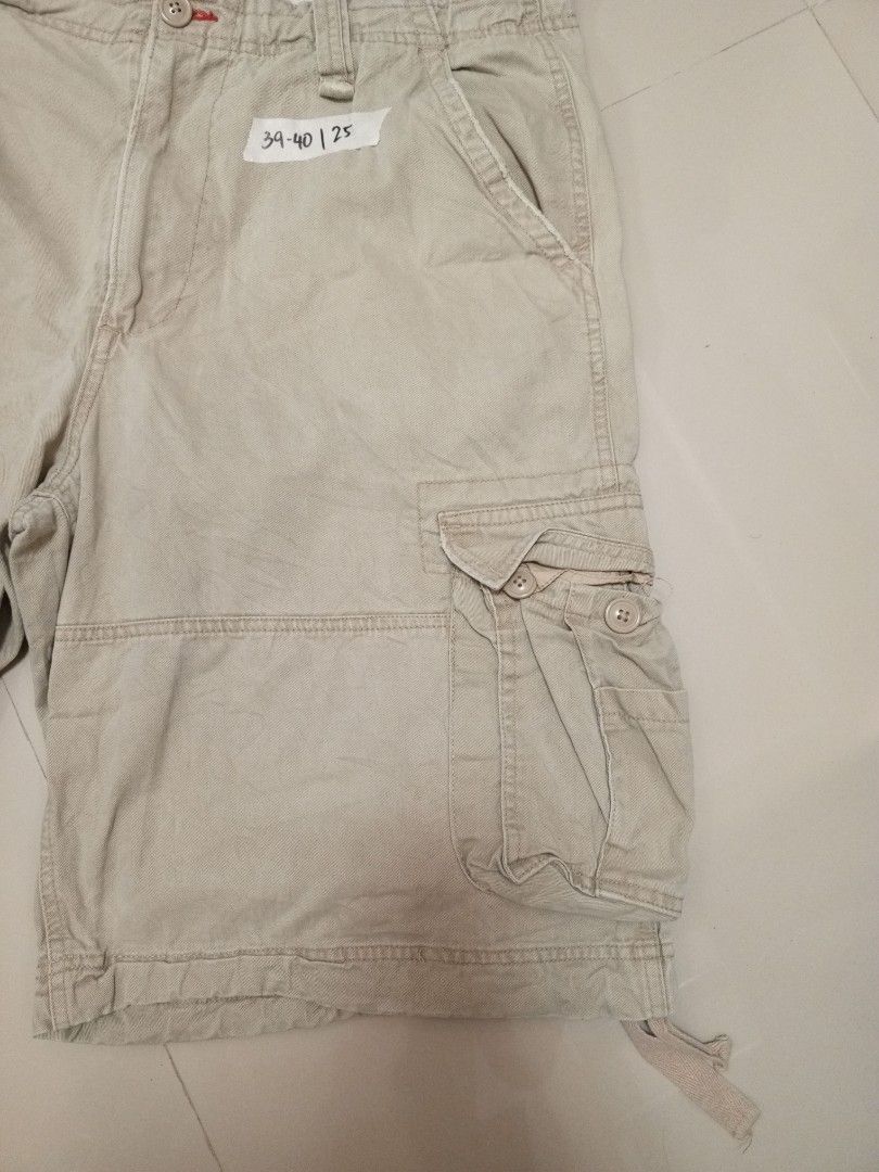 Authentic Trailwear Beige Cargo Shorts Size 38 (Category: Shorts) located in Orani. Submitted by thriftniea (Listing ID 1466041559, Image 3). Description: SIZE 40 LENGTH 25 - Brand: Authentic Trailwear - Size: 38 - Color: Classic beige - Style: Heavy utility cargo shorts - Features: Multiple side and back pockets, button closures, and drawstrings at the leg hems - Durability: Sturdy fabric with double-stitched seams - Condition: Great for outdoor