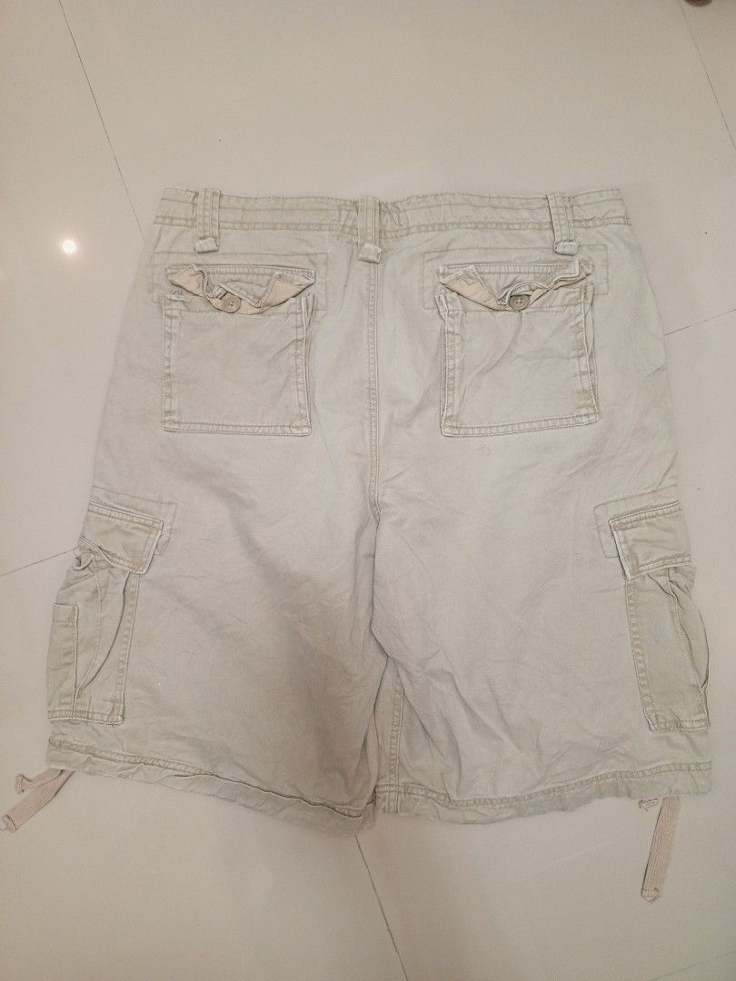 Authentic Trailwear Beige Cargo Shorts Size 38 (Category: Shorts) located in Orani. Submitted by thriftniea (Listing ID 1466041559, Image 2). Description: SIZE 40 LENGTH 25 - Brand: Authentic Trailwear - Size: 38 - Color: Classic beige - Style: Heavy utility cargo shorts - Features: Multiple side and back pockets, button closures, and drawstrings at the leg hems - Durability: Sturdy fabric with double-stitched seams - Condition: Great for outdoor