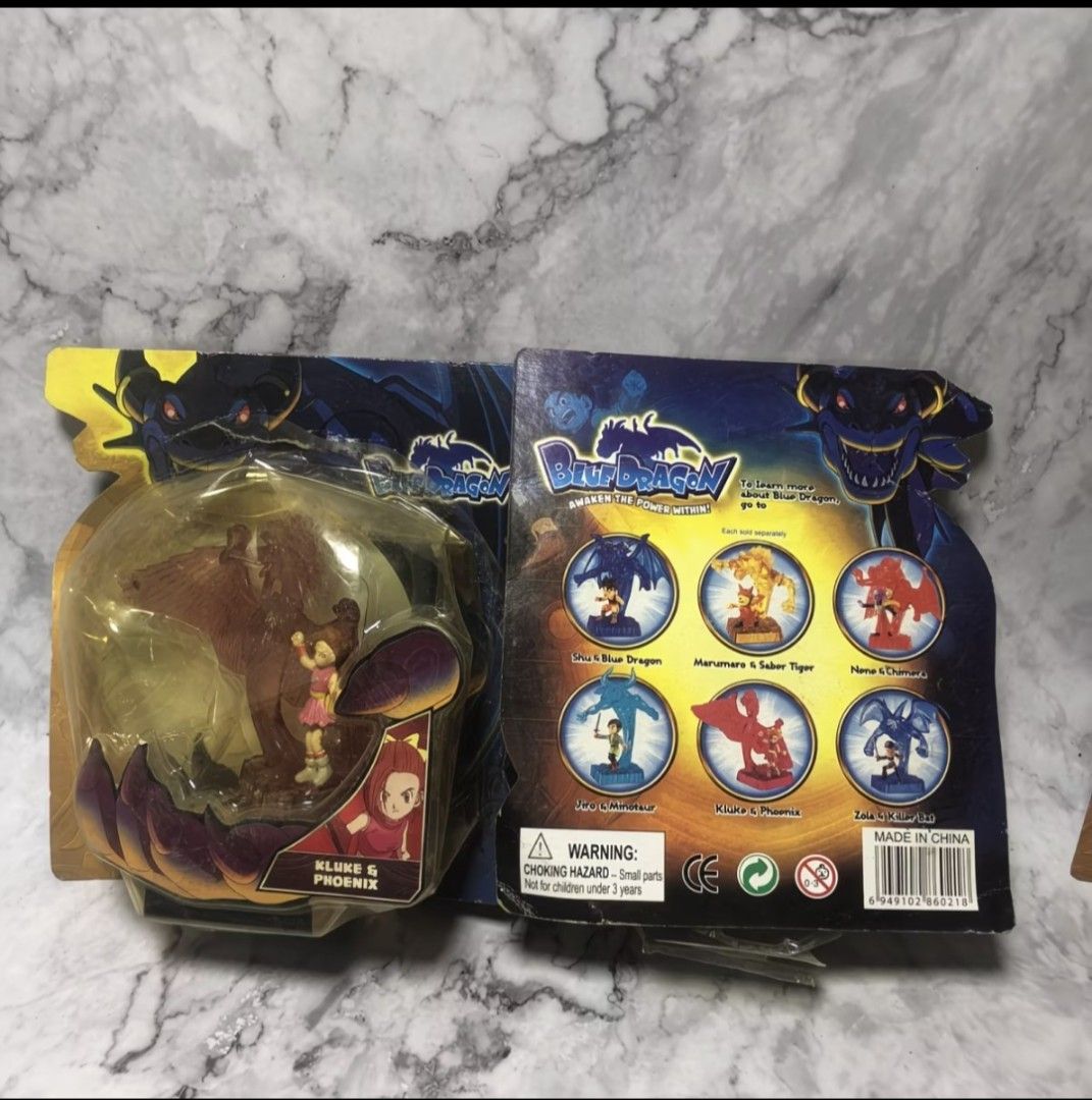 Authentic Vintage Blue Dragon Complete Set (Box Damage Due to Aging) (Category: Figurines & Statues) located in Subic. Submitted by larutoys (Listing ID 1466115339, Image 2). Description: - Complete set of 6 Blue Dragon action figures in original packaging - Includes Shu & Blue Dragon, Marumaro & Saber Tiger, Jiro & Minotaur, Kluke & Phoenix, Nene & Chimera, and Zola & Killer Bat - damage box - Features clear dome packaging with character artwork