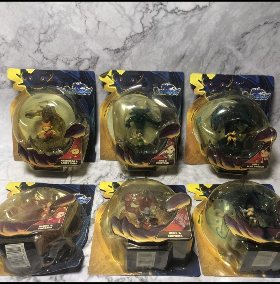 Authentic Vintage Blue Dragon Complete Set (Box Damage Due to Aging) (Category: Figurines & Statues) located in Subic. Submitted by larutoys (Listing ID 1466115339, Image 1). Description: - Complete set of 6 Blue Dragon action figures in original packaging - Includes Shu & Blue Dragon, Marumaro & Saber Tiger, Jiro & Minotaur, Kluke & Phoenix, Nene & Chimera, and Zola & Killer Bat - damage box - Features clear dome packaging with character artwork