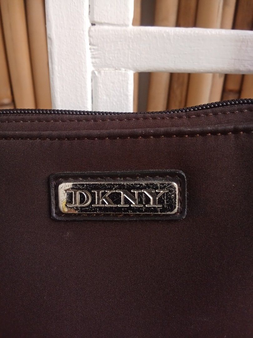 Authentic Vintage DKNY Shoulder Bag (Category: Shoulder Bags) located in Quezon City. Submitted by beccathrift (Listing ID 1466118234, Image 2). Description: Authentic Vintage DKNY shoulder bag Japan sourced Vintage DKNY brown nylon shoulder bag, highlighted by a distinctive rectangular silver-tone logo plaque on the front. Still in very good condition Can pick up or lalamove Payment either Gcash or Metrobank.