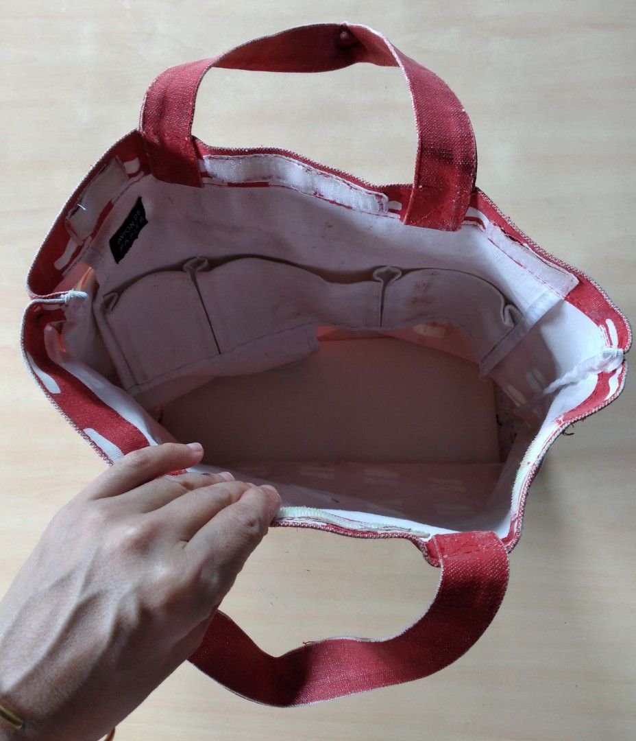 Avion De Papier Red Patterned Thick Canvas Tote Bag (Category: Tote Bags) located in Baguio. Submitted by tipiditis (Listing ID 1466030344, Image 2). Description: - Red canvas tote bag with a white geometric pattern and French phrase - Dual top handles for easy carrying - Roomy interior equipped with multiple slip pockets - Secure built-in zipper closure along the side gusset - Sturdy exterior fabric construction - Flaw: Interior lining has visib