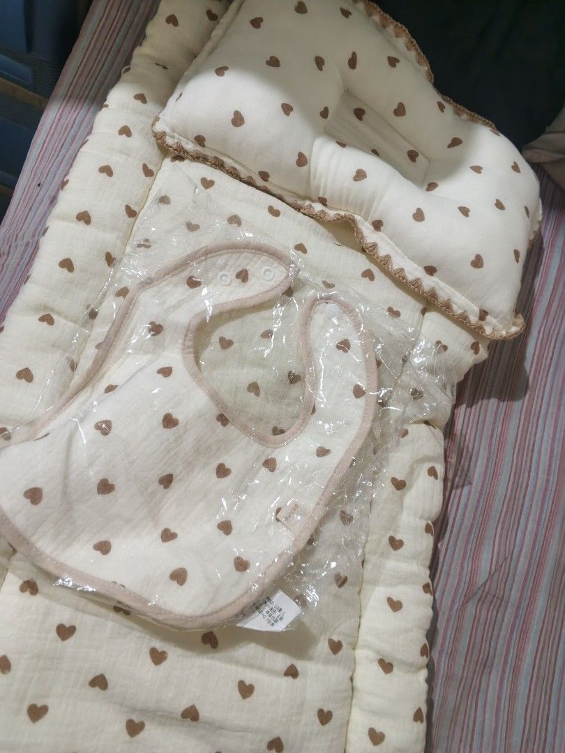 Baby Bedding Set with Pillow and Matching Bib (Category: Cots & Cribs) located in Caloocan City. Submitted by dmrosxix (Listing ID 1466112209, Image 3). Description: - Color/Pattern: Cream with brown heart print - Inclusions: Soft cushioned mattress, matching contoured pillow, and brand-new baby bib (still sealed in plastic) - Design: Neutral style, perfect for any nursery theme - Care: Easy to wash fabric - Condition: Excellent, ready for your l