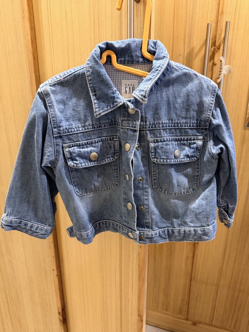 Baby Gap Denim Jacket (Category: Babies & Kids Fashion) located in Quezon City. Submitted by welovedclothing (Listing ID 1466048565, Image 1). Description: - Brand: Baby Gap - Size: 2 Years - Material: 100% Cotton - Color: Classic blue wash with blue & white gingham collar lining - Design: Front button closure, dual chest flap pockets, and large embroidered heart on the back - Origin: Made in Indonesia - Condition: Great little layer for cooler d