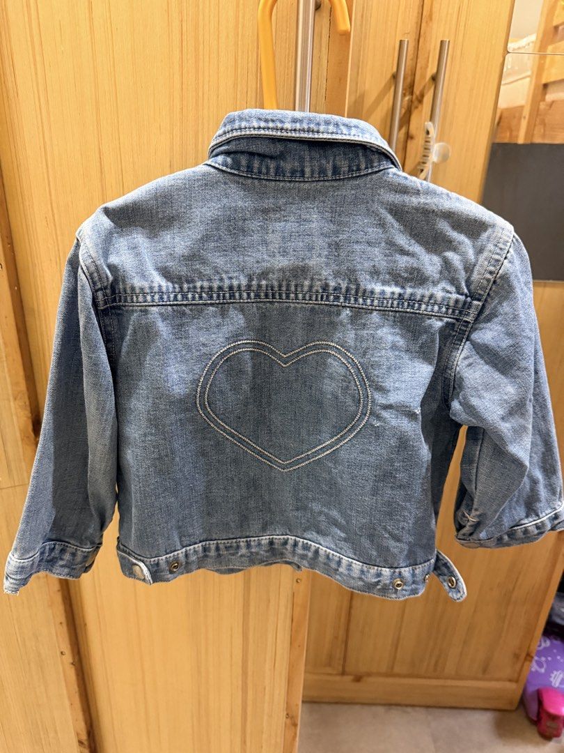 Baby Gap Denim Jacket (Category: Babies & Kids Fashion) located in Quezon City. Submitted by welovedclothing (Listing ID 1466048565, Image 3). Description: - Brand: Baby Gap - Size: 2 Years - Material: 100% Cotton - Color: Classic blue wash with blue & white gingham collar lining - Design: Front button closure, dual chest flap pockets, and large embroidered heart on the back - Origin: Made in Indonesia - Condition: Great little layer for cooler d