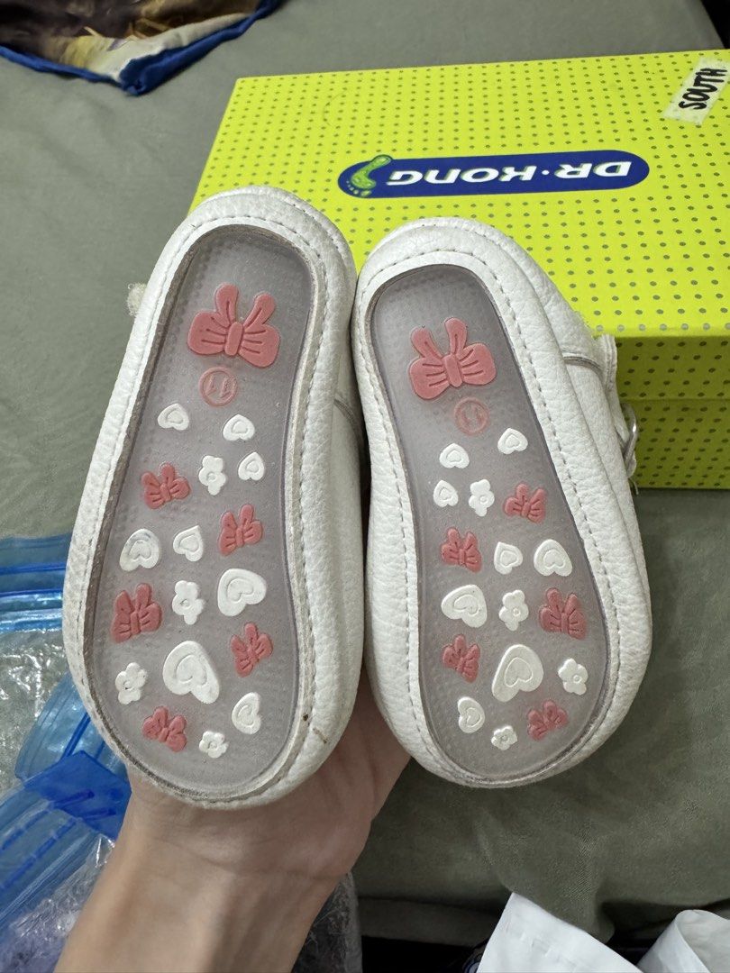 Baby shoes (Category: Babies & Kids Fashion) located in Paranaque City. Submitted by kgsantos (Listing ID 1466073071, Image 3). Description: - Color: White - Size: 11 (fits 3 to 6 months) - Design: Heart cutout on the front with a stylish T-strap - Closure: Easy side Velcro for quick wear and removal Dirty white shoes - needs cleaning White with heart cut out - used thrice Barbie gold shoes - used once Get all three pairs for 300.