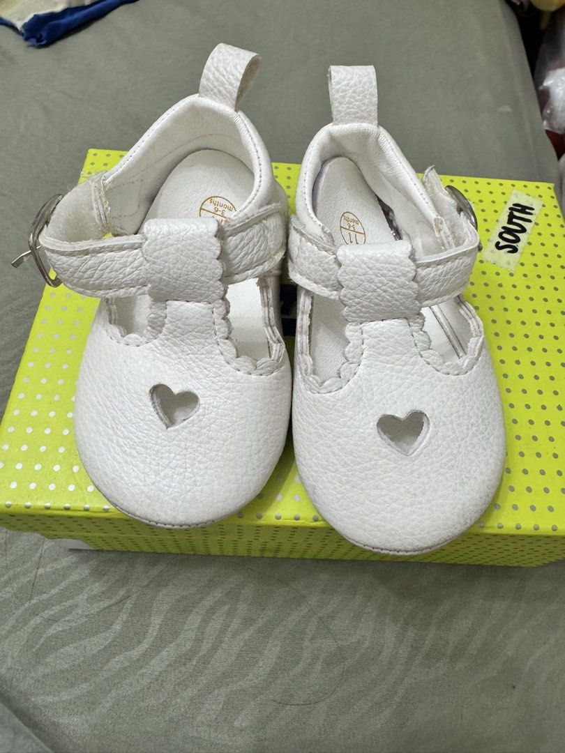 Baby shoes (Category: Babies & Kids Fashion) located in Paranaque City. Submitted by kgsantos (Listing ID 1466073071, Image 2). Description: - Color: White - Size: 11 (fits 3 to 6 months) - Design: Heart cutout on the front with a stylish T-strap - Closure: Easy side Velcro for quick wear and removal Dirty white shoes - needs cleaning White with heart cut out - used thrice Barbie gold shoes - used once Get all three pairs for 300.