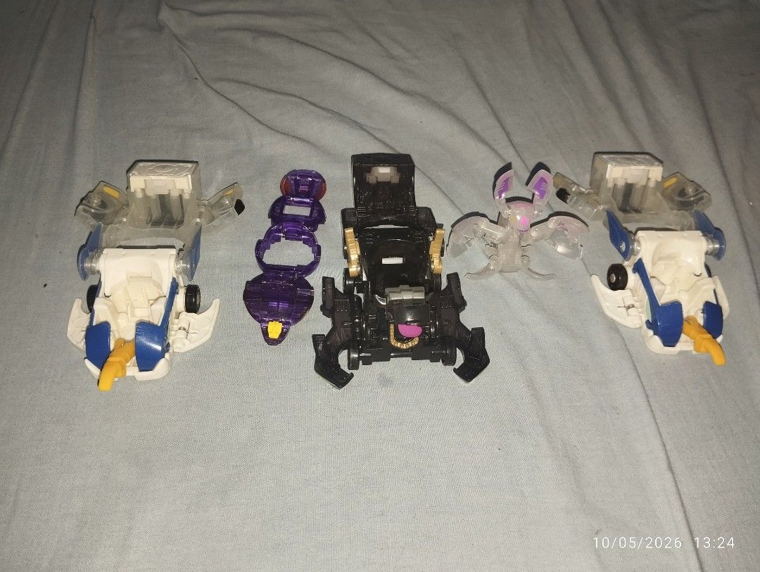 Bakugan with ghost mecard laucher (Category: Vehicle & Diecast Models) located in Manila. Submitted by watertubig_091123 (Listing ID 1466011327, Image 2). Description: - Bakugan collector's lot featuring 3 transforming vehicles and 2 action figures - Includes 2 clear white and blue vehicles with folding parts and 1 black vehicle with gold and pink details - Comes with a purple transparent figure ring and a translucent winged figure - Features var