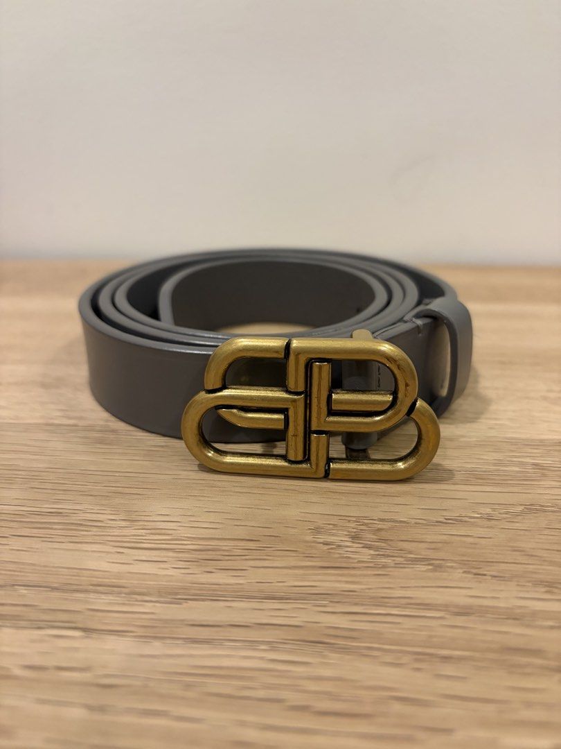 Balenciaga BB Buckle Leather Belt (Category: Belts) located in San Pedro. Submitted by tin.teodosio (Listing ID 1466046816, Image 1). Description: - Brand: Balenciaga - Material: Grey leather in clean condition with minimal wear - Hardware: Antique brass-tone BB buckle - Fit: Standard width, ideal for daily wear - Styling: Easily pairs with casual denim or smart trousers - Condition: Excellent pre-loved condition - Size: 90cm.