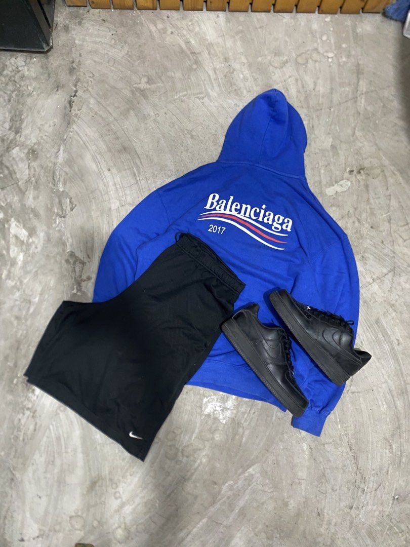 Balenciaga Campaign Hoodielack (Category: Hoodies) located in Las Pinas. Submitted by 2fly.margiela (Listing ID 1465959062, Image 1). Description: - Complete streetwear outfit set in one easy purchase - Blue Balenciaga campaign hoodie with distinct white and red lettering - Comfortable black Nike athletic shorts featuring the iconic white swoosh - Versatile black sneakers to complete the vibe - Skip the hassle of mixing and matching—grab the full