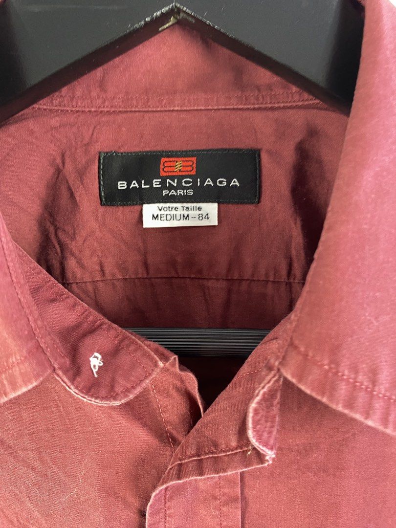 Balenciaga Paris Maroon Button-Up Shirt Medium-84 (Category: Shirts) located in Manila. Submitted by declutterpromax (Listing ID 1466019133, Image 2). Description: - Brand: Balenciaga Paris - Color: Rich maroon / burgundy - Size: Medium-84 - Fit: Traditional tailored fit with curved hem - Details: Long sleeves, pointed collar, front chest pocket, white button closures - Condition: Clean stitching, great for smart-casual wear.