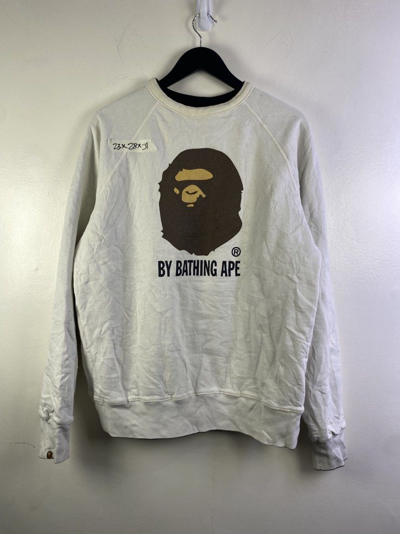 BAPE Reversible A Bathing Ape Sweatshirt (Category: Coats, Jackets and Outerwear) located in Manila. Submitted by declutterpromax (Listing ID 1466000809, Image 1). Description: - BAPE reversible crewneck sweatshirt - White side: BAPE head graphic on front, Generals graphic on back - Black side: Busy Works circular logo on front, rainbow stripes with ape head on back - Tagged measurements: 23" (pit-to-pit) x 28" (length) x 31" (sleeve) - Condition
