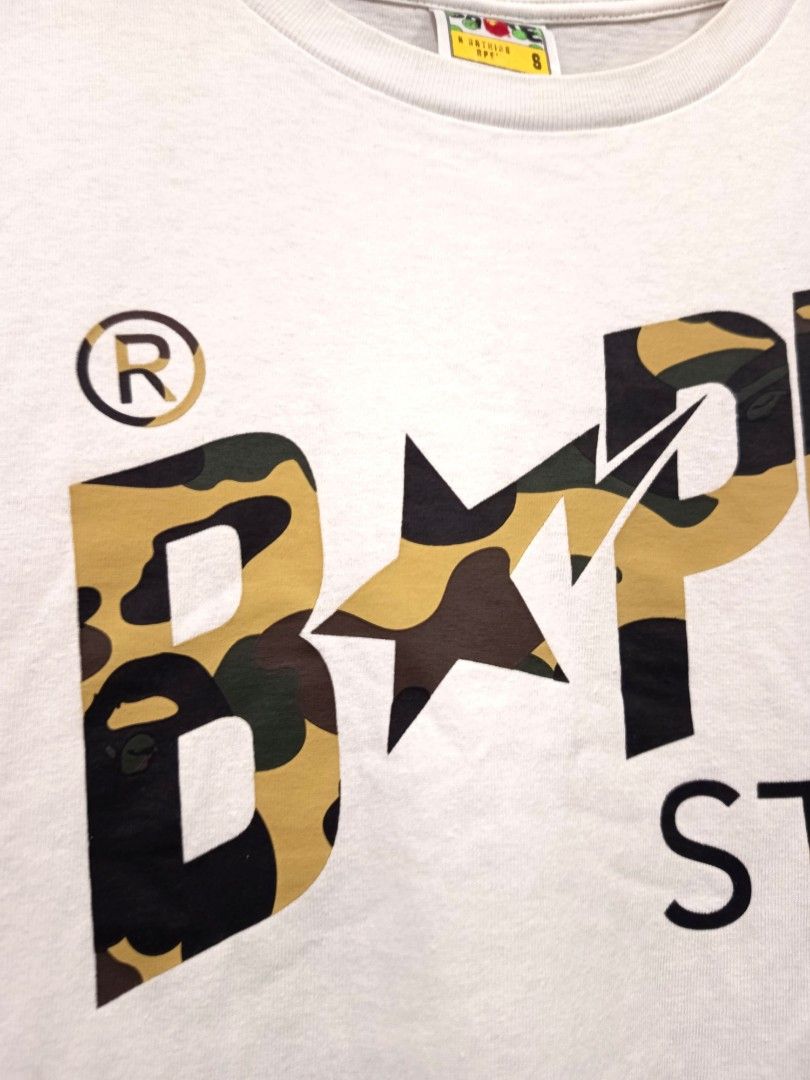 Bape Sta First Camo Script T Shirt (Category: Tshirts & Polo Shirts ) located in Dagupan City. Submitted by plugofallthreads (Listing ID 1466121956, Image 3). Description: Bape Sta First Camo Script T Shirt Size: Men's Small Length: 25 inches Width: 18 inches Authentic. In very good condition. 10/10 print. 9/10 cloth. Price: Php 1,500 plus sf DM TO PURCHASE.