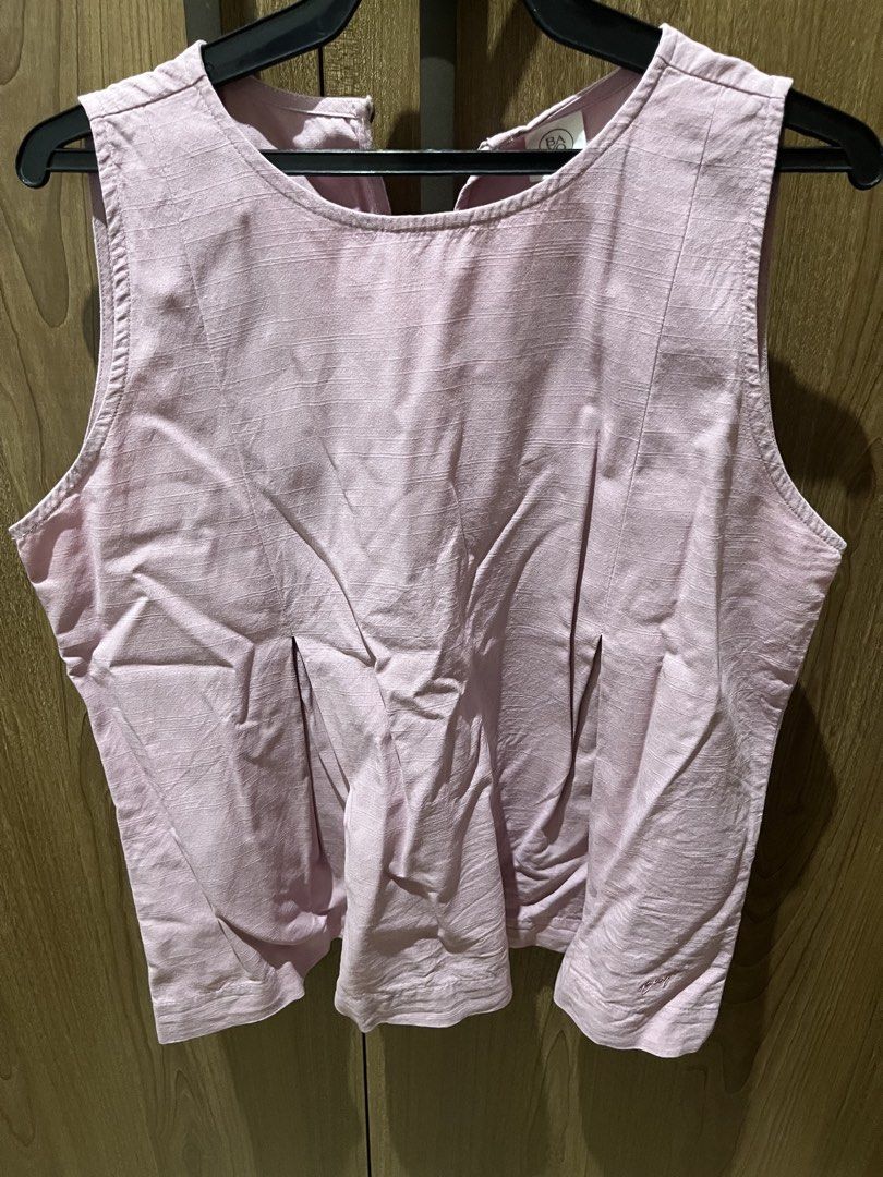 Bayo Pink Sleeveless Top (Category: Sleeveless) located in Quezon City. Submitted by epictiger.c6451a (Listing ID 1465965107, Image 1). Description: - Brand: Bayo - Color: Pink - Size: Large (True to size, standard cut) - Design: Sleeveless, round neckline with back button closure - Details: Textured fabric with stylish front pleats - Style: Simple and casual, perfect to pair with jeans or shorts.
