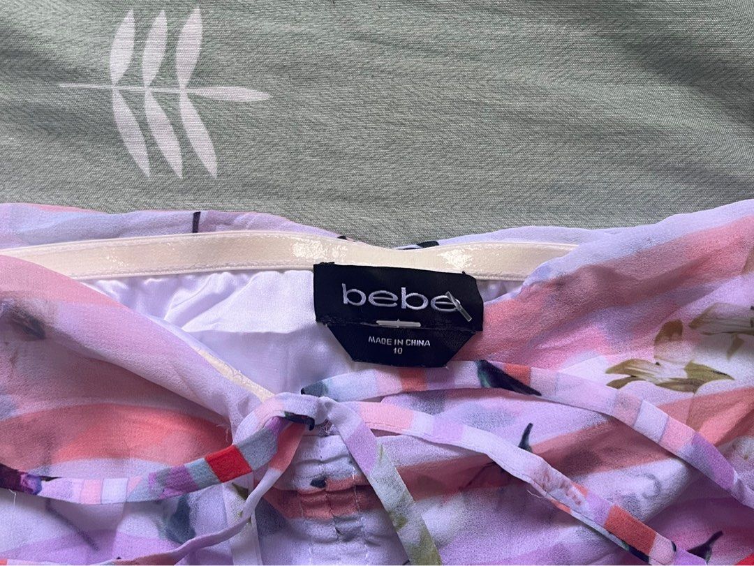bebe floral off-shoulder top size 10 (Category: Blouses) located in Manila. Submitted by thrifted.shits (Listing ID 1466036993, Image 3). Description: - Brand: bebe - Size: 10 - Design: Pink & purple striped with vibrant all-over floral prints - Sleeves: Short puff sleeves with ruffled cuffs - Details: Center front ruching with drawstring ties & adjustable hem tie - Material: Lightweight, airy chiffon - Condition: like new - Perfect for: Date nig