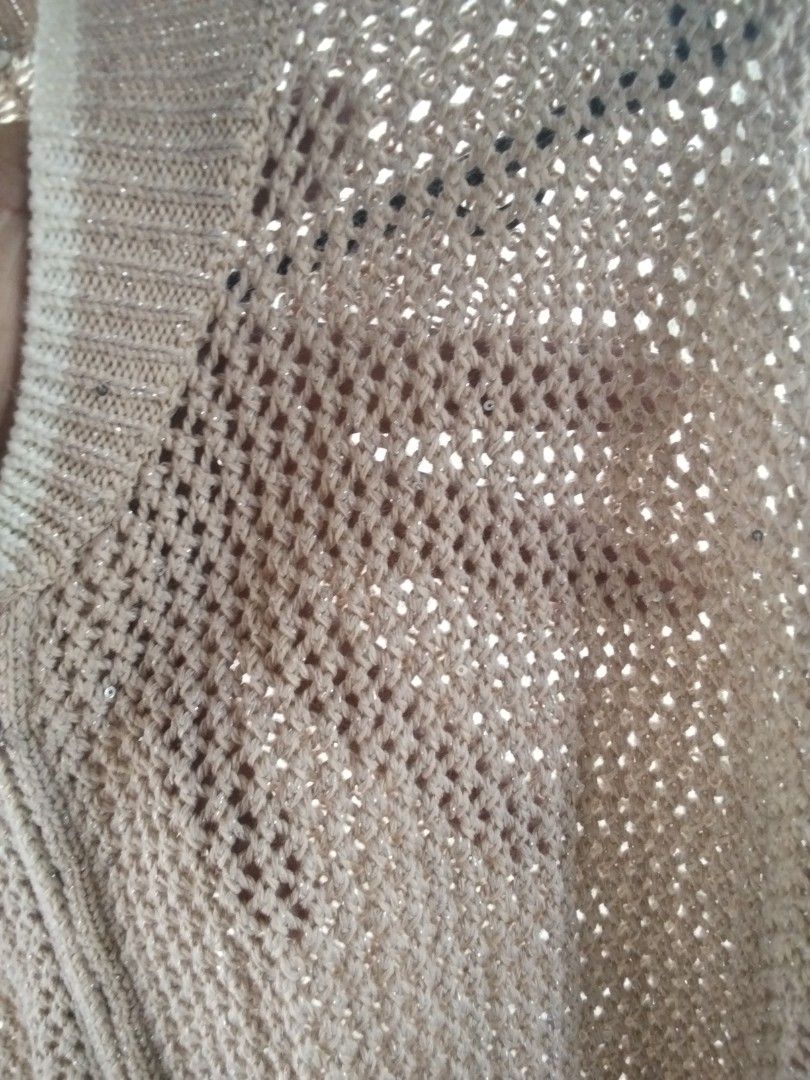 Beige Knit Zip-Up Cardigan with Sequins (Category: Coats, Jackets and Outerwear) located in Alaminos. Submitted by dangpreloved01 (Listing ID 1465964923, Image 3). Description: - Color: Beige - Fit: Loose fit with long sleeves - Design: Open mesh crochet pattern with a full front zipper - Details: Ribbed collar and cuffs, with subtle sequins woven into the yarn for extra sparkle - Use: Great lightweight layering piece for cooler evenings or air-c