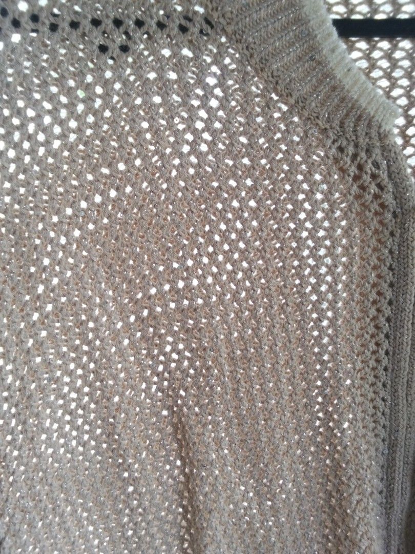Beige Knit Zip-Up Cardigan with Sequins (Category: Coats, Jackets and Outerwear) located in Alaminos. Submitted by dangpreloved01 (Listing ID 1465964923, Image 2). Description: - Color: Beige - Fit: Loose fit with long sleeves - Design: Open mesh crochet pattern with a full front zipper - Details: Ribbed collar and cuffs, with subtle sequins woven into the yarn for extra sparkle - Use: Great lightweight layering piece for cooler evenings or air-c