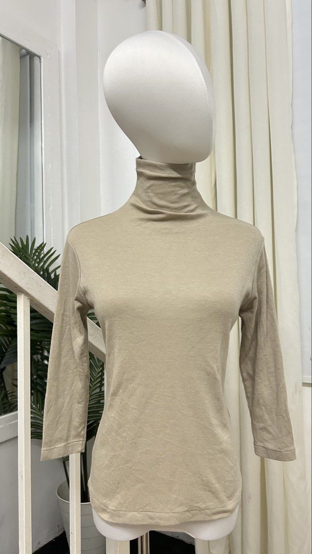 Beige Lightweight Turtleneck 3/4 Sleeve Top | Minimalist Basic | S-M (Category: Longsleeves) located in San Jose del Monte. Submitted by vanessabarredo (Listing ID 1466150132, Image 3). Description: Excellent condition. Minimalist beige/taupe turtleneck top in a lightweight, soft-looking fabric. Features a high neck and 3/4 sleeves — a versatile neutral basic that works well on its own or for layering. Measurements: Width: 17.5” Length: 23” Best 