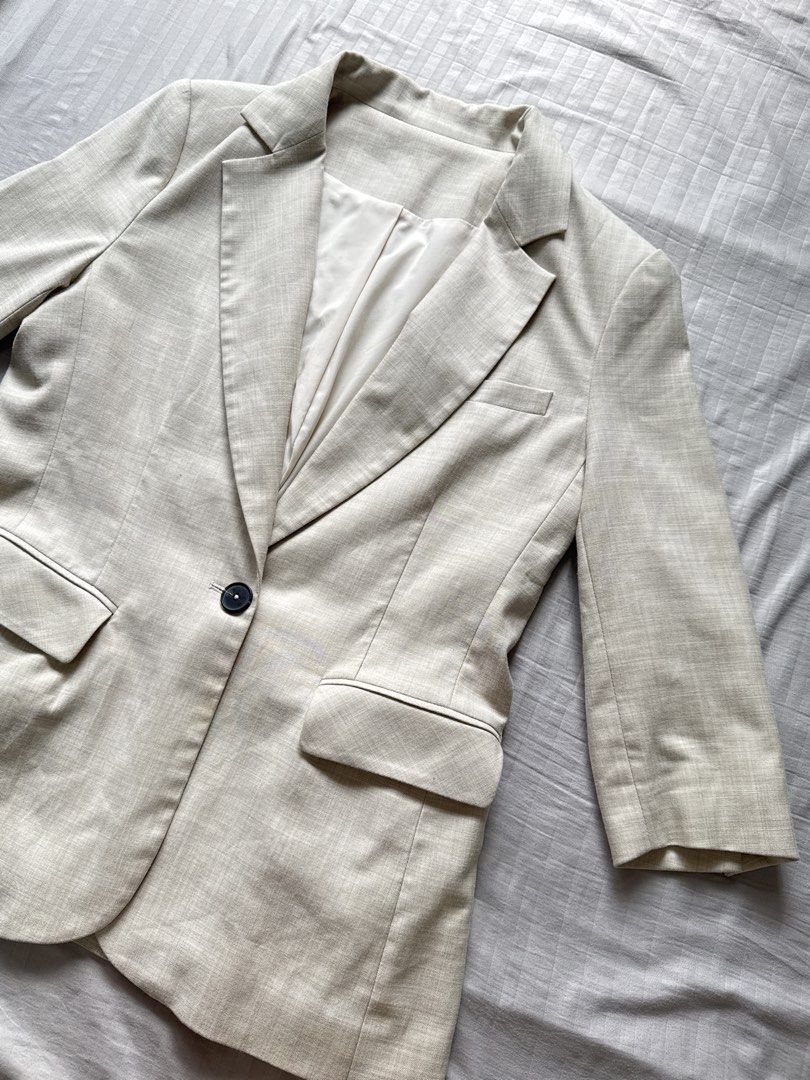 Beige Neutral Single Button Blazer Jacket (Category: Coats, Jackets and Outerwear) located in Mandaluyong City. Submitted by ilougeranc08517 (Listing ID 1465980264, Image 2). Description: - Color: Versatile neutral beige with a subtle textured finish - Design: Single dark front button closure, two front flap pockets, and a classic chest welt pocket - Fit & Details: Stylish three-quarter length sleeves with clean tailoring and full white inner lin