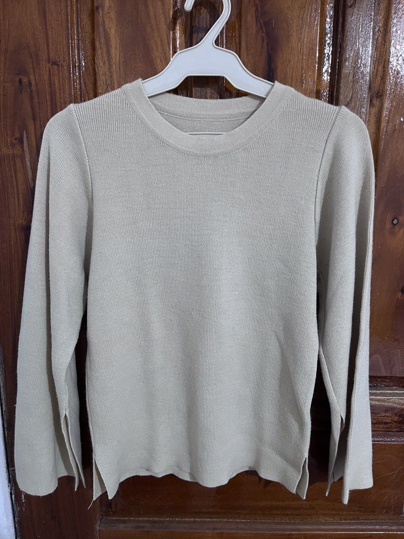 Beige ribbed knit sweater with split sleeves (Category: Longsleeves) located in Baguio. Submitted by gbwardrobe (Listing ID 1466093943, Image 1). Description: - Color: Beige - Texture: Vertical ribbed knit - Design: Round neckline, long sleeves with split cuffs, and small side slits at the hem - Style: Versatile everyday basic, perfect for pairing with denim or skirts.