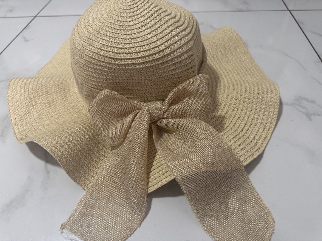 Beige Sun Hat with Large Ribbon (Category: Hats & Beanies) located in Manila. Submitted by decluterthings888 (Listing ID 1465956325, Image 3). Description: - Color: Neutral beige - Design: Wide brim with a stylish burlap-style bow - Material: Lightweight and easy to pack for trips - Perfect for: Beach days, park strolls, and summer outings - Versatile: Matches tons of summer outfits.