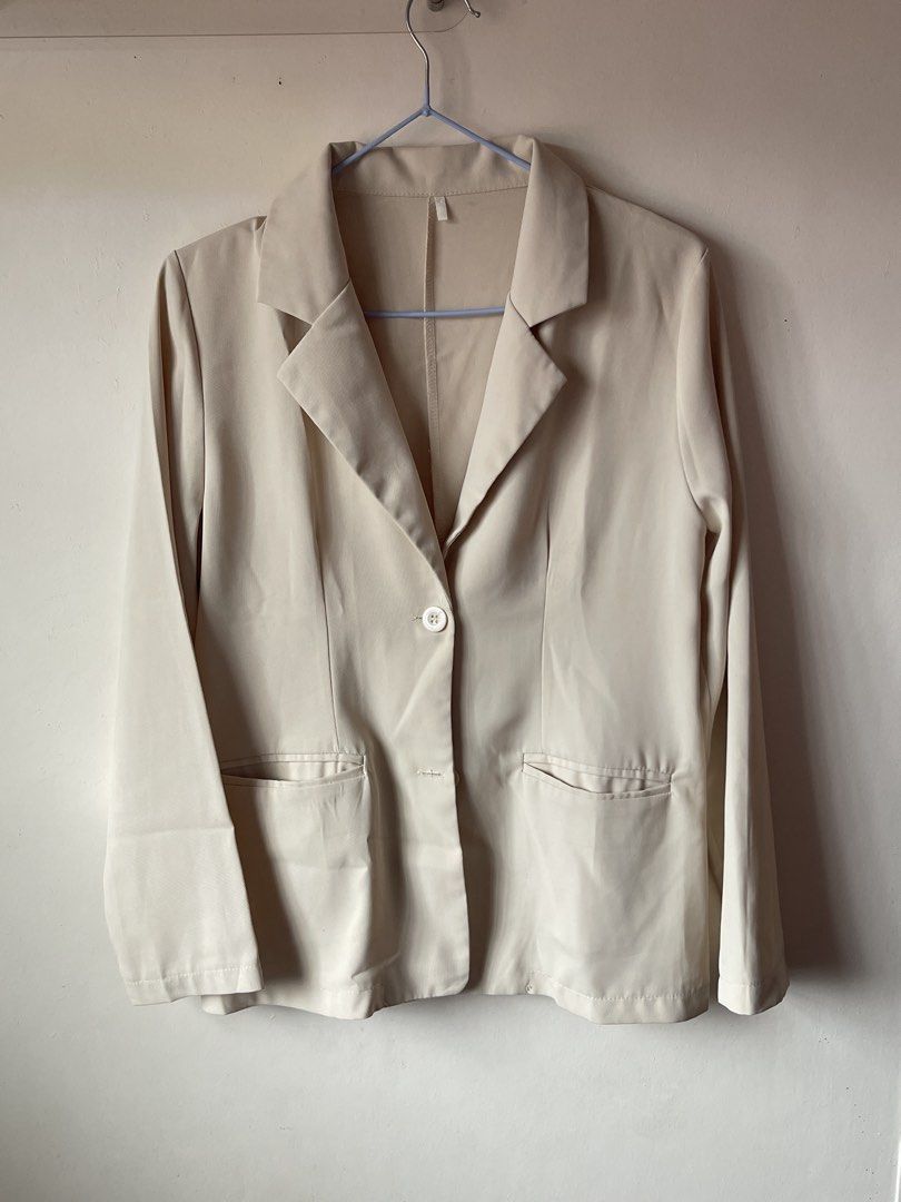 Beige tailored blazer jacket with front pockets and button (Category: Coats, Jackets and Outerwear) located in Calamba. Submitted by everyday.closet (Listing ID 1466015904, Image 1). Description: fits small to medium - Color: Neutral beige - Design: Classic lapel collar, single-button front closure, and structured shoulders - Pockets: Two functional front pockets with flaps - Sleeves: Long sleeves - Fabric: Lightweight and breathable, perfect for