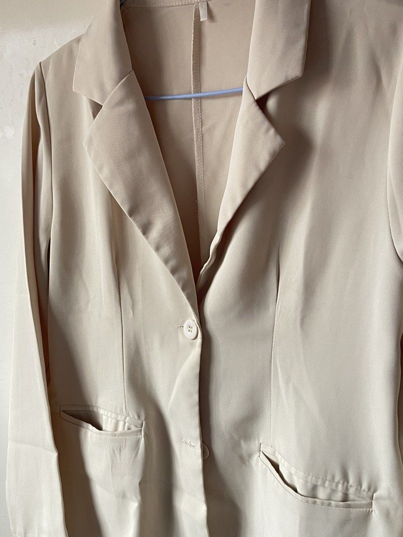 Beige tailored blazer jacket with front pockets and button (Category: Coats, Jackets and Outerwear) located in Calamba. Submitted by everyday.closet (Listing ID 1466015904, Image 2). Description: fits small to medium - Color: Neutral beige - Design: Classic lapel collar, single-button front closure, and structured shoulders - Pockets: Two functional front pockets with flaps - Sleeves: Long sleeves - Fabric: Lightweight and breathable, perfect for