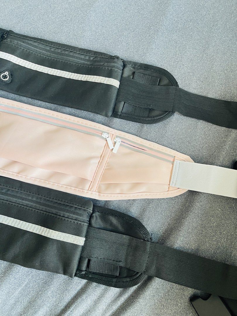 Belt Bag (Category: Belt bags, Clutches and Pouches) located in Manila. Submitted by ttbbkk (Listing ID 1465974584, Image 2). Description: - Colors available: 2x Black, 1x Light Pink - Secure zippered pockets for your phone and keys - Adjustable elastic strap with buckle fits most waists comfortably - Reflective front strip for safe night runs - Built-in headphone cable port - Lightweight, no-bounce material stays close to the body while jogging.