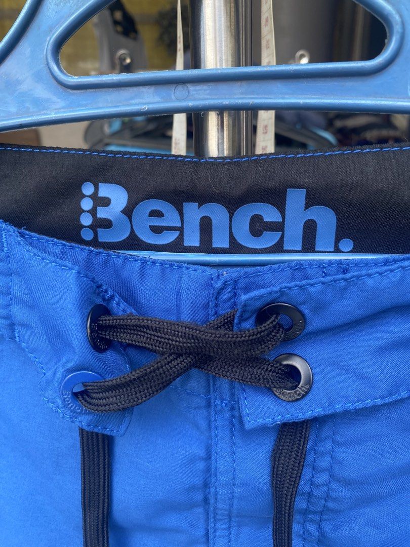 Bench Blue Board Shorts Size 30 (Category: Swim Trunks & Board Shorts) located in San Jose del Monte. Submitted by gigjhoe (Listing ID 1465987883, Image 3). Description: - Brand: Bench - Size: 30” -Length-21” - Color: Bright blue with graphic print on right leg - Details: Black inner waistband with large Bench logo, black drawstring with metal grommets - Origin: Made in China - Condition: Great option for swimming or beach days.