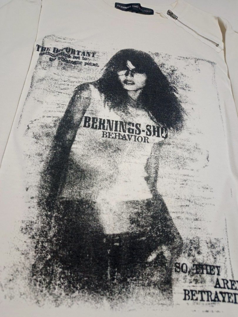 Bernings-Sho Graphic Longsleeve (Category: Longsleeves) located in Calabanga. Submitted by bekneegear (Listing ID 1466123482, Image 2). Description: - Brand: Bernings-Sho - Color: Off-white - Size: Medium (Tag attached) - Design: Large graphic print with 'BERNINGS-SHO BEHAVIOR' text - Details: Diagonal zipper near the collar, brand labels on neck and sleeve hem - Style: Unique grunge streetwear.