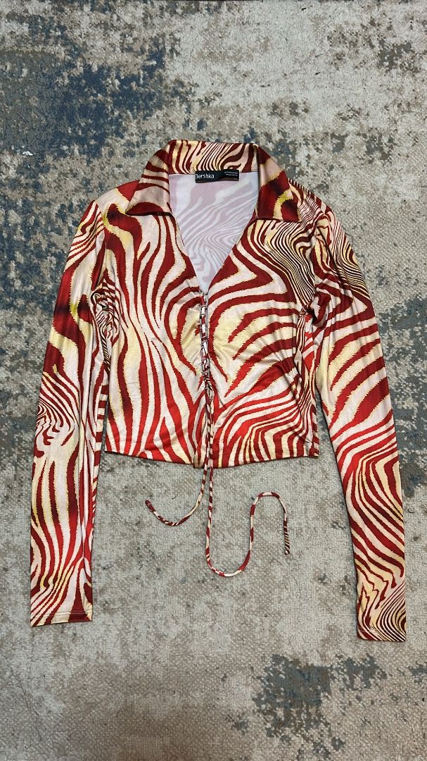 Bershka longsleeve top (Category: Longsleeves) located in Manila. Submitted by cvntlab (Listing ID 1466119763, Image 1). Description: - Red and yellow abstract wavy animal print - Long sleeve mesh style top with stretch - Collared neck with front lace-up tie closure - Trendy cropped length .