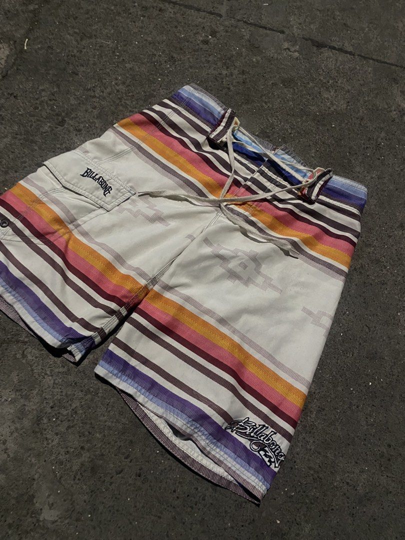 Billabong Striped Aztec Board Shorts Size 30 (Category: Swim Trunks & Board Shorts) located in Manila. Submitted by mystic.enrique_romulo (Listing ID 1465986148, Image 1). Description: - Brand: Billabong - Size: 30 - Material: 100% polyester (quick-dry) - Design: White base with colorful horizontal stripes and Aztec geometric patterns - Features: Side cargo pocket with embroidered logo, additional logo hit near bottom hem, and drawstring waist cl
