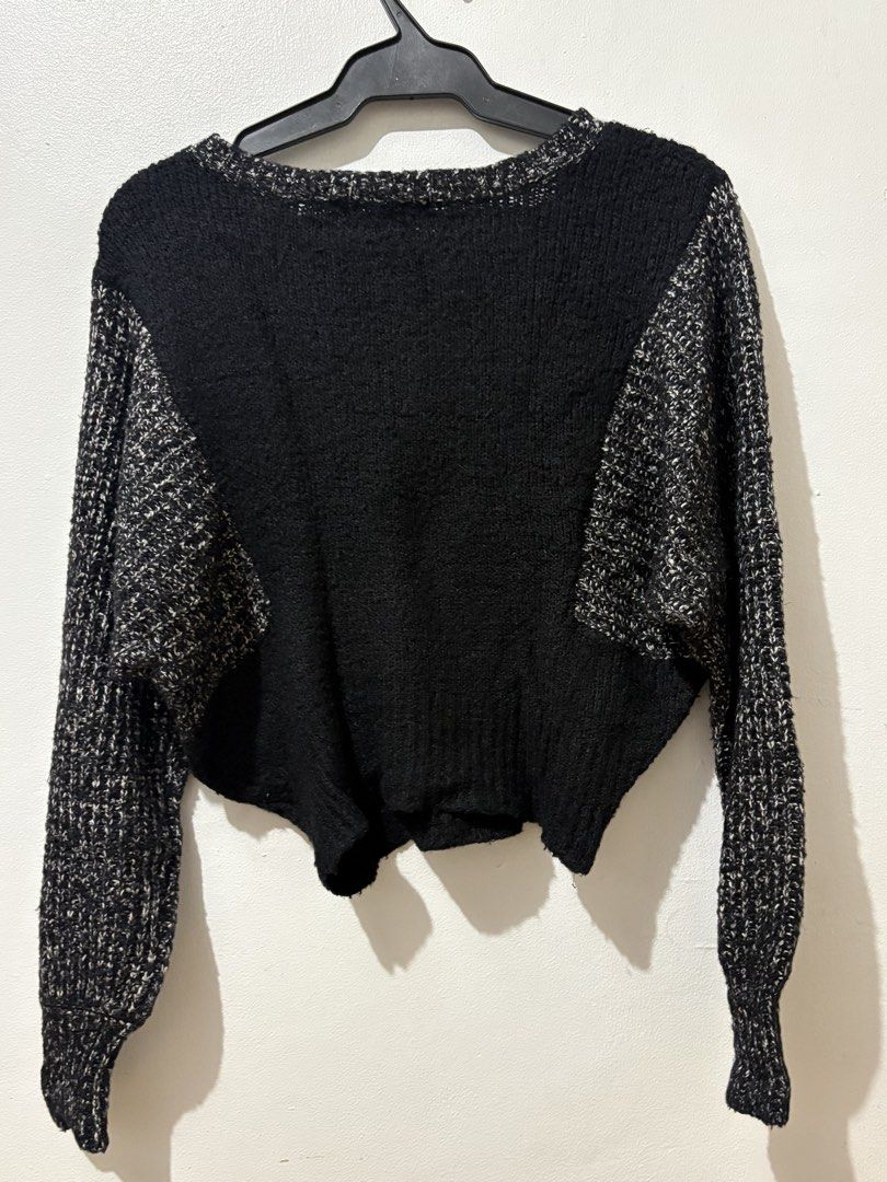 Black and White Knit Crop Sweater (Category: Longsleeves) located in Manila. Submitted by nykji96 (Listing ID 1465964526, Image 2). Description: - Color: Classic black with contrasting black-and-white textured sleeves and neckline - Fit: Relaxed batwing arms with a trendy cropped hem - Neckline: Wide scoop neck style - Texture: Eye-catching chunky knit on the sleeves for a unique two-tone look - Styling: Perfect to pair with your favorite high-wa