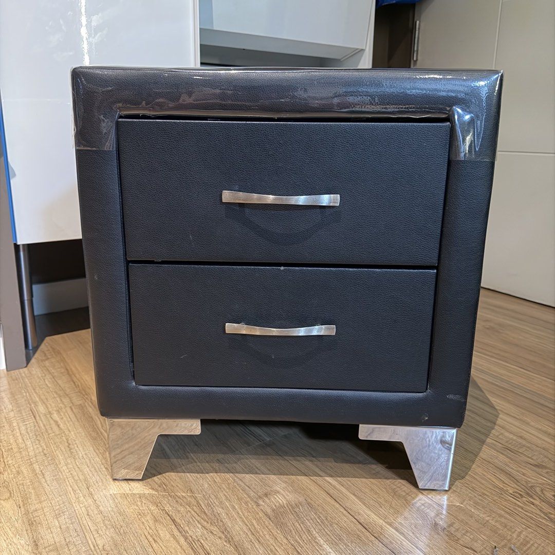 Black Faux Leather 2-Drawer Nightstand Bedside Table (Category: Shelves, Cabinets & Racks) located in Manila. Submitted by gminshie (Listing ID 1466043439, Image 1). Description: For Sale: 2x Bed Side Cabinet — 3k each. 48x40x54 Good as new. No issue. (Plastic cover on top can be removed. For dust purposes only. 😅).